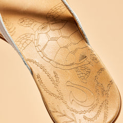 OluKai Women | Honu Women’s Leather Sandals - Bright White / Golden Sand