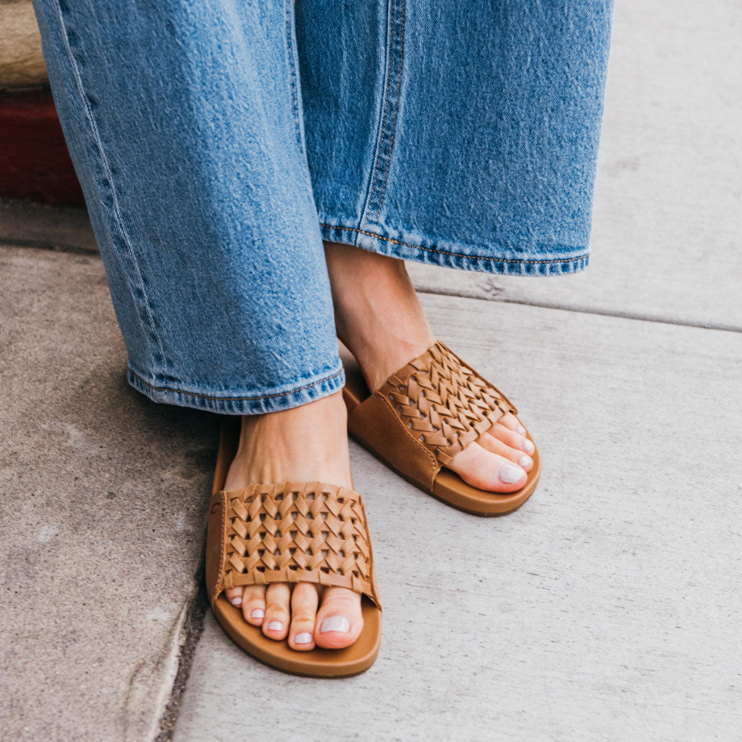 OluKai Women | Kāmola Women’s Leather Slide Sandals - Tan